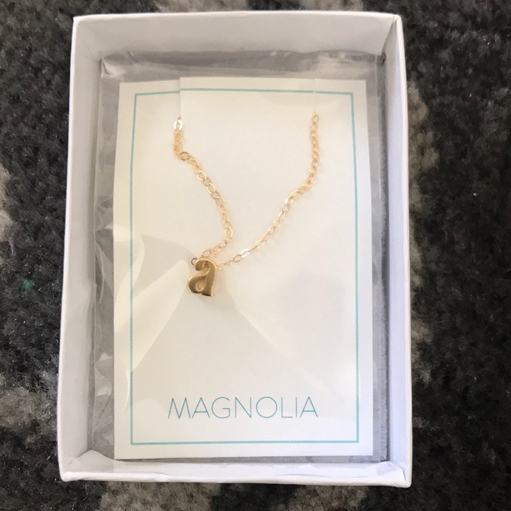 Gold letter A necklace.